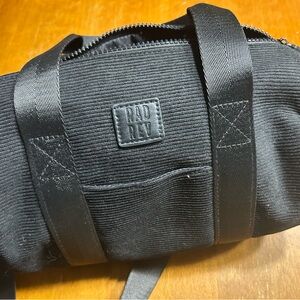 Rad Rev black corduroy barrel bag.